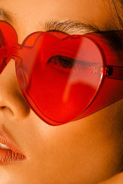Close up of woman in heart shape glasses