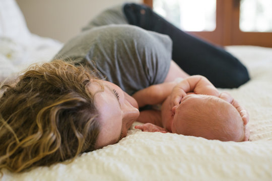 Mom and baby on bed
