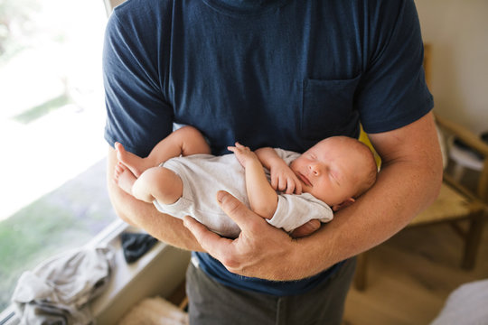 Man holding new baby inside.
