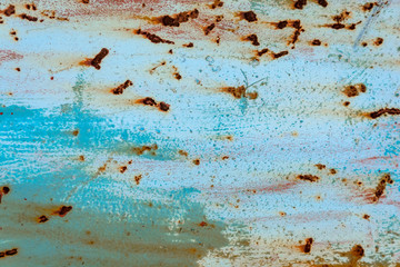 The blue metallic texture is covered with rust