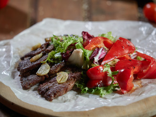 Slices of roast beef with garlic and red pepper.
