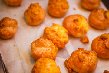 Delicious eclairs. Bakery in the oven. Confectionery. Yellow small ecriles