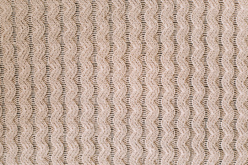 Knitted background. Knitting pattern of wool. Knitting. Texture of knitted woolen  fabric for wallpaper and an abstract background