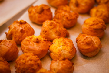 Delicious eclairs. Bakery in the oven. Confectionery. Yellow small ecriles