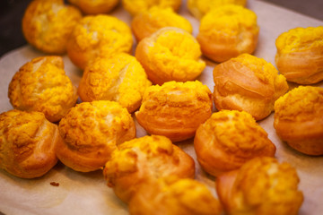 Delicious eclairs. Bakery in the oven. Confectionery. Yellow small ecriles