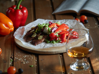 Slices of roast beef with garlic and red pepper.