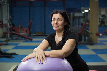 Senior woman in gym with fitball. close-up. copy space.