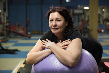 Senior woman in gym with fitball. close-up. copy space.