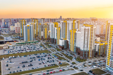 Huge residential area multi-storey high-rise buildings to the horizon and large parking car, the evening sky view sunset light.
