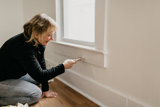 Middle Aged Woman Painting Home