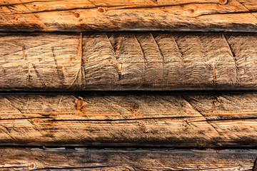 Wooden wall of beams of gray-brown color, texture