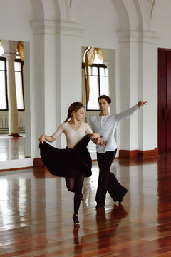 Dancing young couple in hall