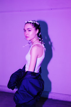 Slim woman in modern outfit looking at camera