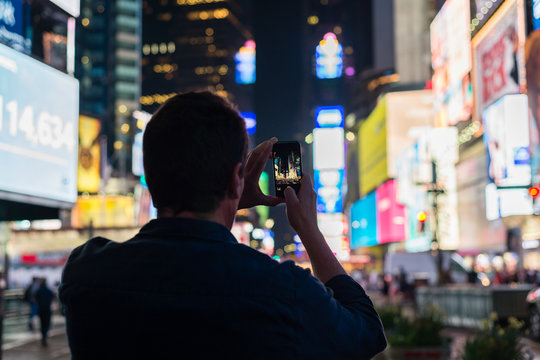 man taking photo at Times Square
