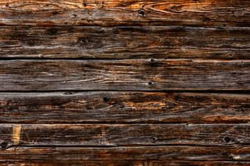 Horizontal boards of dark color, wall, texture.
