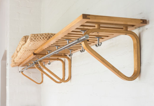 Beautiful empty wooden coat hanger on wall