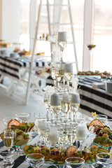 Wedding slide champagne for bride and groom indoors.
