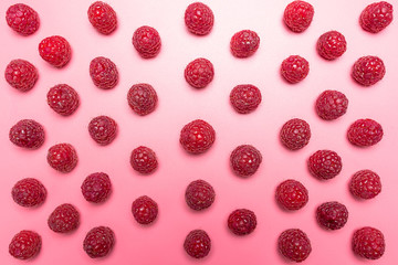 Pattern made from fresh raspberries, top view, flat lay pattern, isolated on a light pink background.