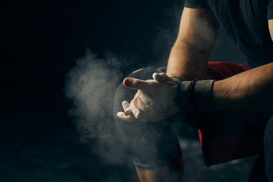 Hands with chalk ready for exercising.