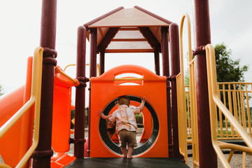 Toddler Playing on Playground with His Mother in Summertime