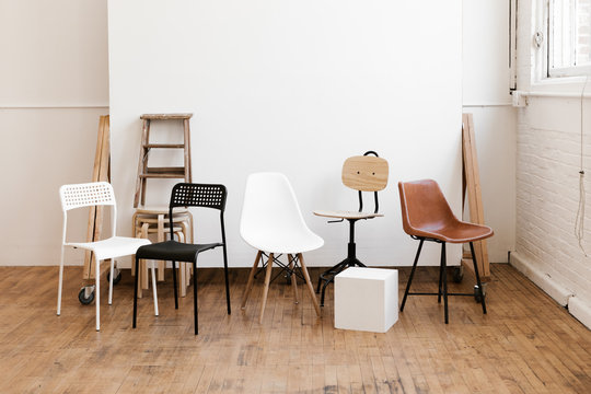 chairs and props in modern white industrial photo studio
