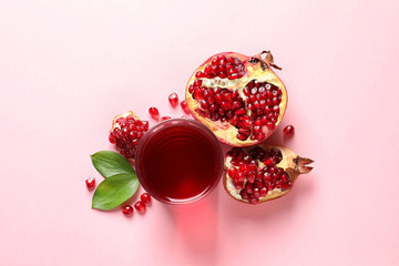 Glass of pomegranate juice and fresh fruits on color background, top view