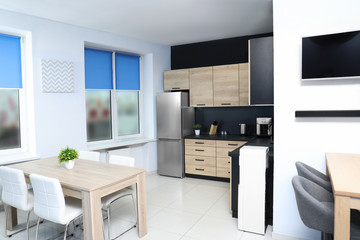Cozy modern kitchen interior with new furniture and appliances