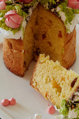 Traditional cake decorated with roses and chocolate eggs on a white plate. Easter cake is traditionally baked on one of the big Christian Easter holidays.
