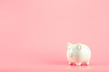 white piggy bank on pink background. - save and management concept.