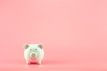 white piggy bank on pink background. - save and management concept.
