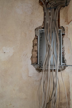 Freshly drawn electricly wiring hanging over a newly installed fuse box