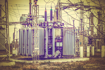Obraz premium Multi-phase high-voltage transformer of high power at the substation for lighting urban electric circuits.