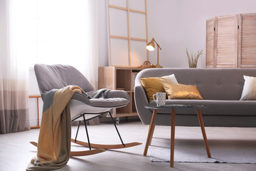 Stylish living room interior with comfortable sofa. Idea for home decor