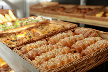 Wicker trays with fresh bakery products in store