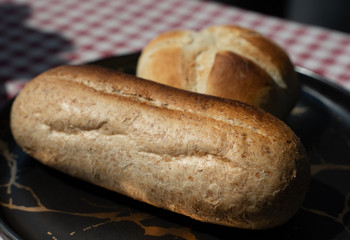 toasted bread placed in black plate,isolated on red patterned napkin
