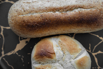toasted bread placed in black plate,isolated on red patterned napkin