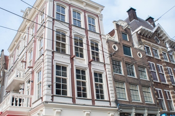 Fototapeta na wymiar Typical old houses of Amsterdam, Netherlands under blue sky in spring