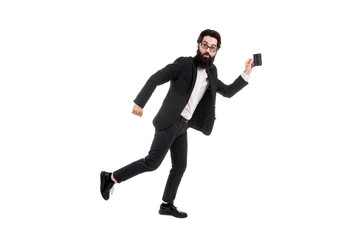 Full length studio portrait of a surprised bearded businessman running with a mini suitcase, isolated on white background