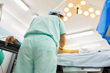 Nurse cleaning a patient before procedure