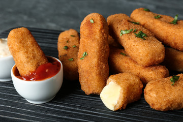 Cheese sticks and sauce on board, closeup