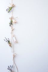 Various medicinal herbs aqnd flowers hanged on the rope are dried along wooden wall