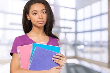 Pretty Young female student on background