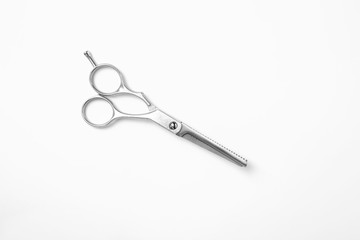 New thinning scissors on white background, top view. Professional hairdresser tool