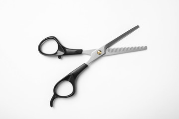 New thinning scissors on white background, top view. Professional hairdresser tool