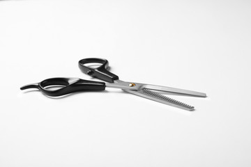 New thinning scissors on white background. Professional hairdresser tool