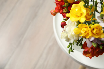 Beautiful spring freesia flowers on table, view from above. Space for text