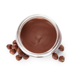 Glass jar with tasty chocolate cream and hazelnuts isolated on white, top view