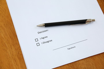 agreement and pen on wooden table