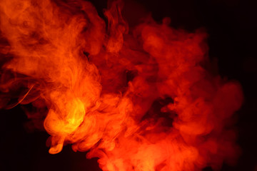 Imitation of bright flashes of orange-red flame. Background of abstract colored smoke.
