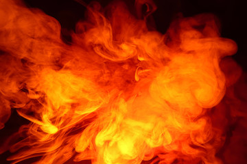 Imitation of bright flashes of orange-red flame. Background of abstract colored smoke.